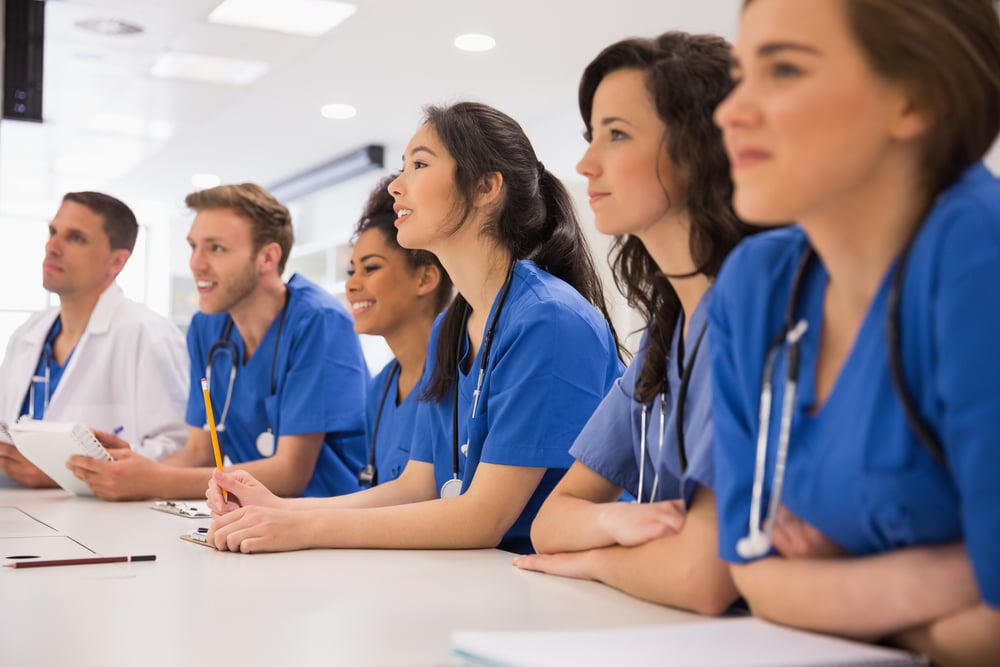 Medical students listening sitting at desk at the university-2-1 Medical students listening sitting at desk at the university-2-1